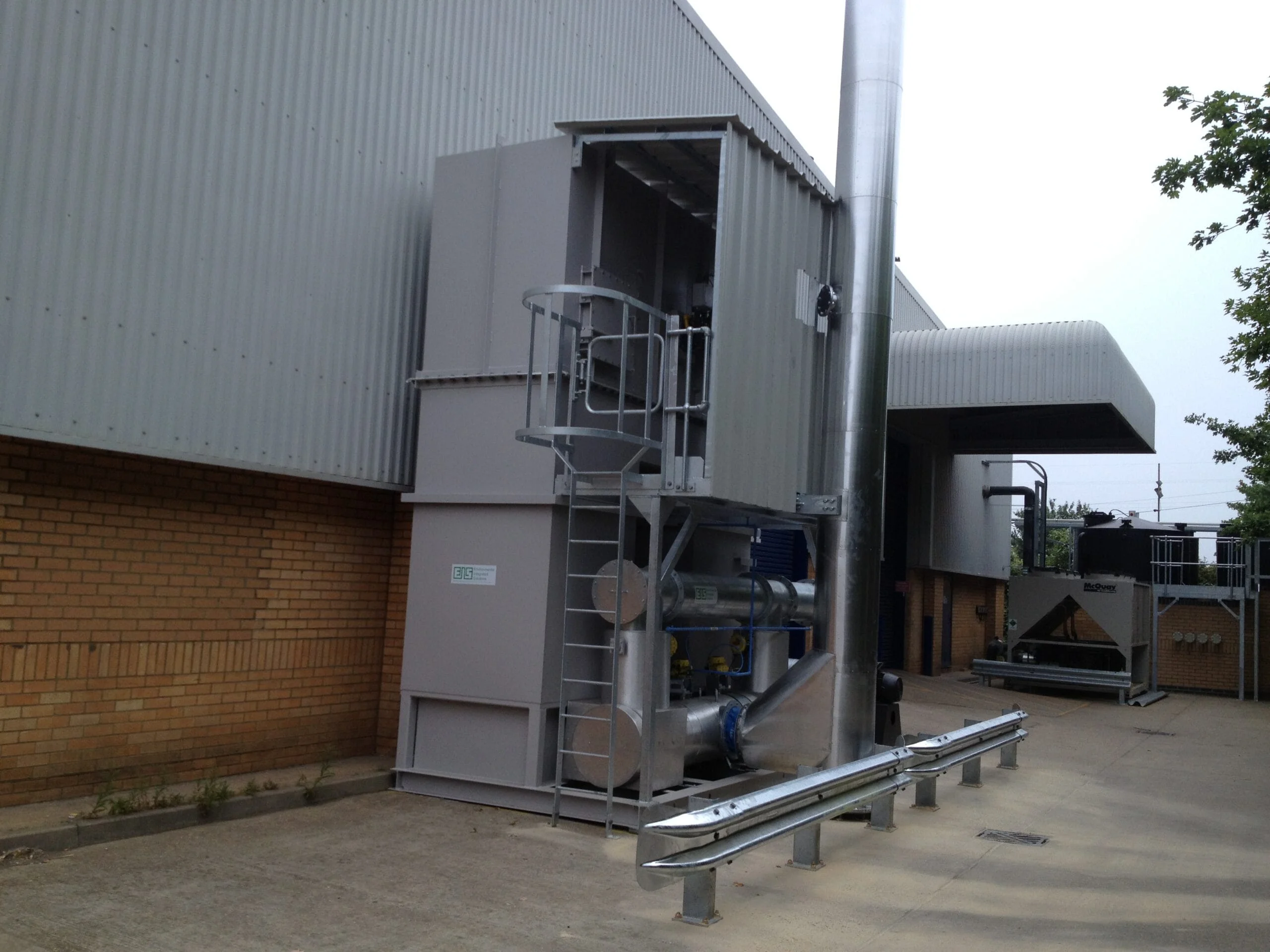 RTO Exterior view of an industrial EIS air treatment system with stainless steel piping, exhaust stack.