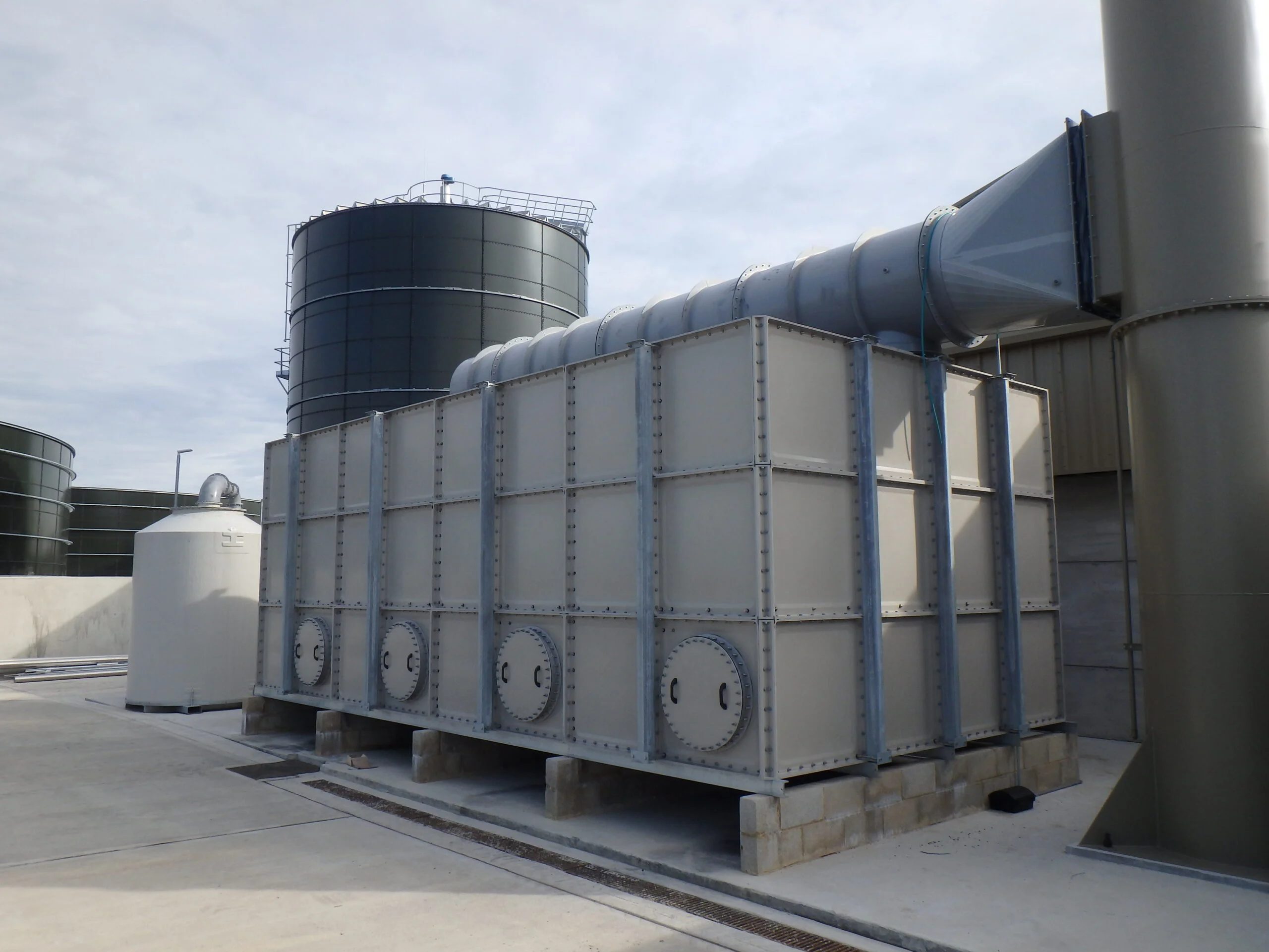 Large-scale industrial air emissions control system with process ducting.